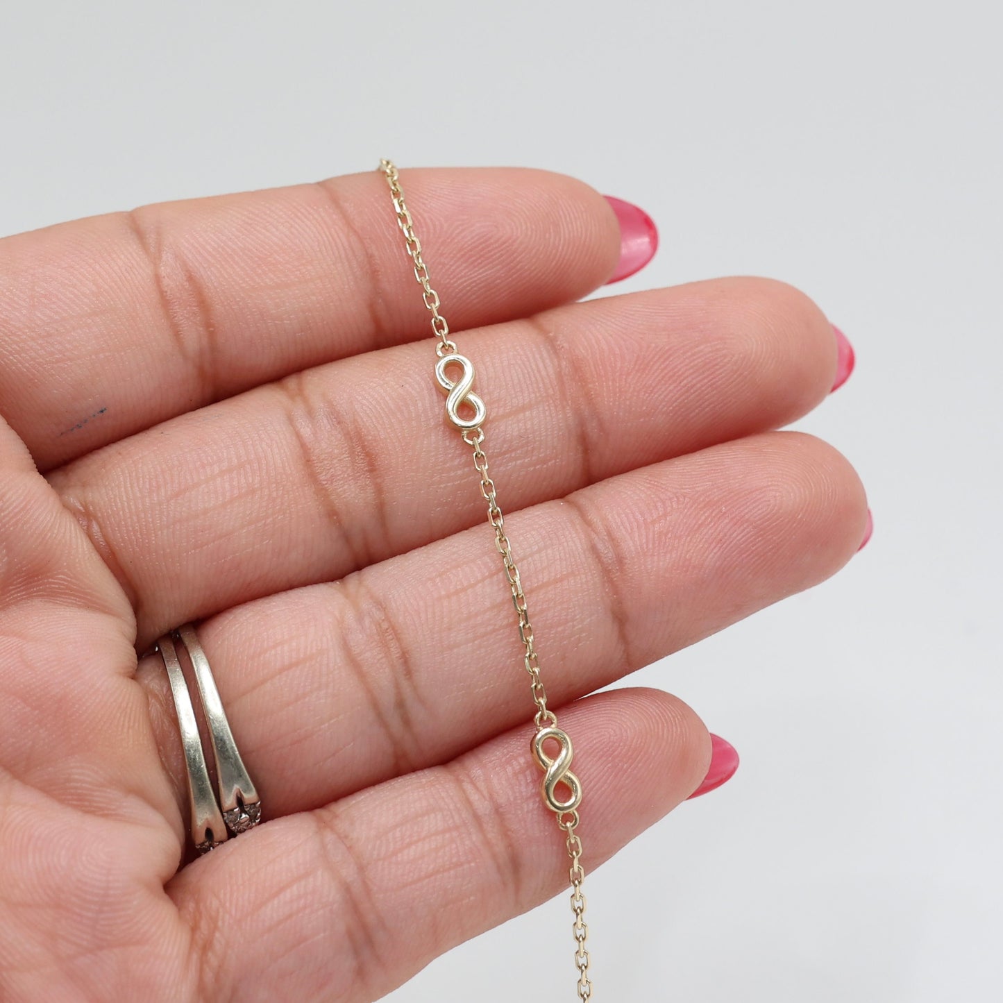14KT GOLD 4 SMALL INFINITY BRACELET